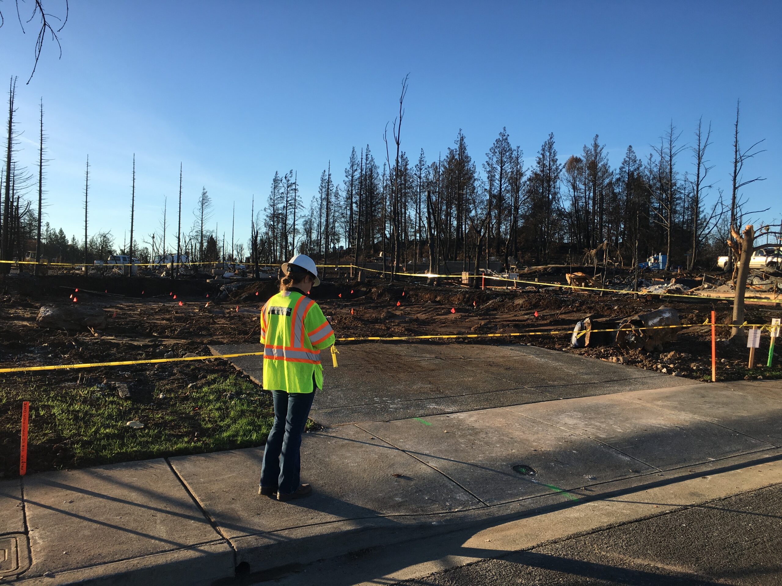 Field Worker Surveys Fire Damage A field worker surveys fire damage in California.