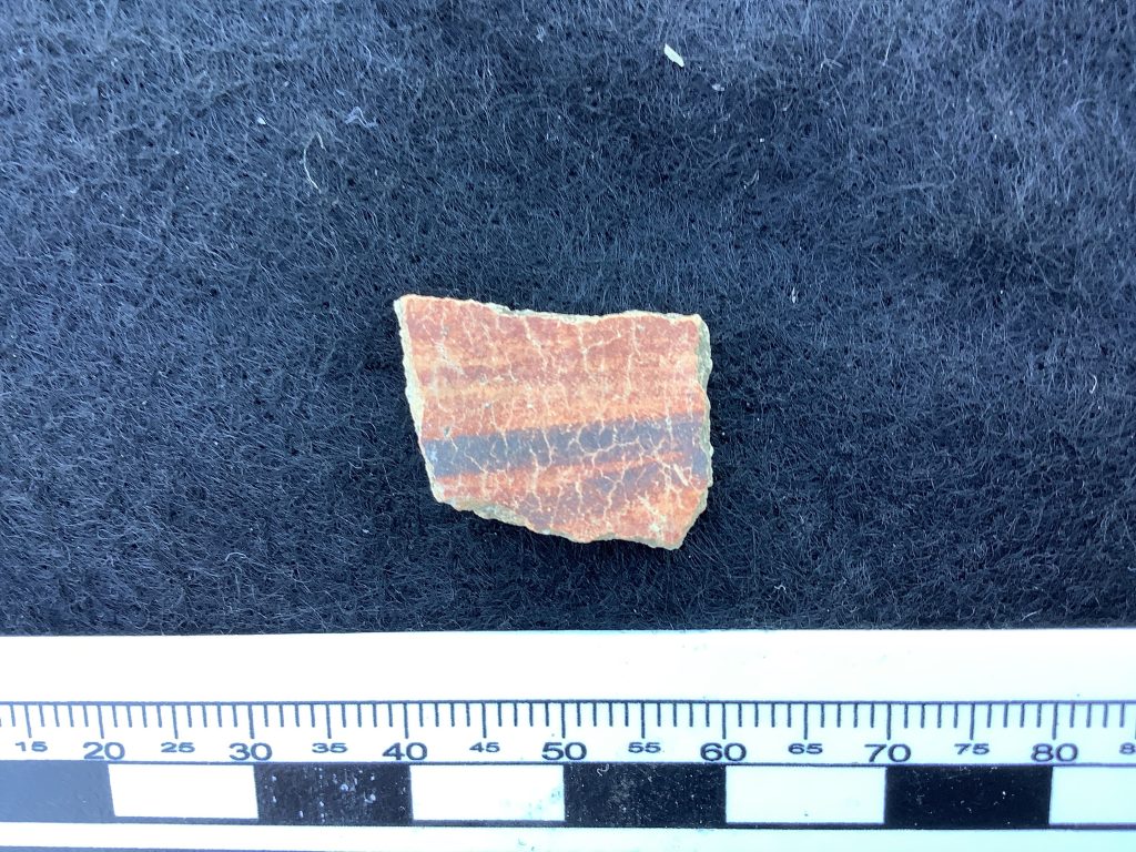Black on orange ceramic sherd exterior