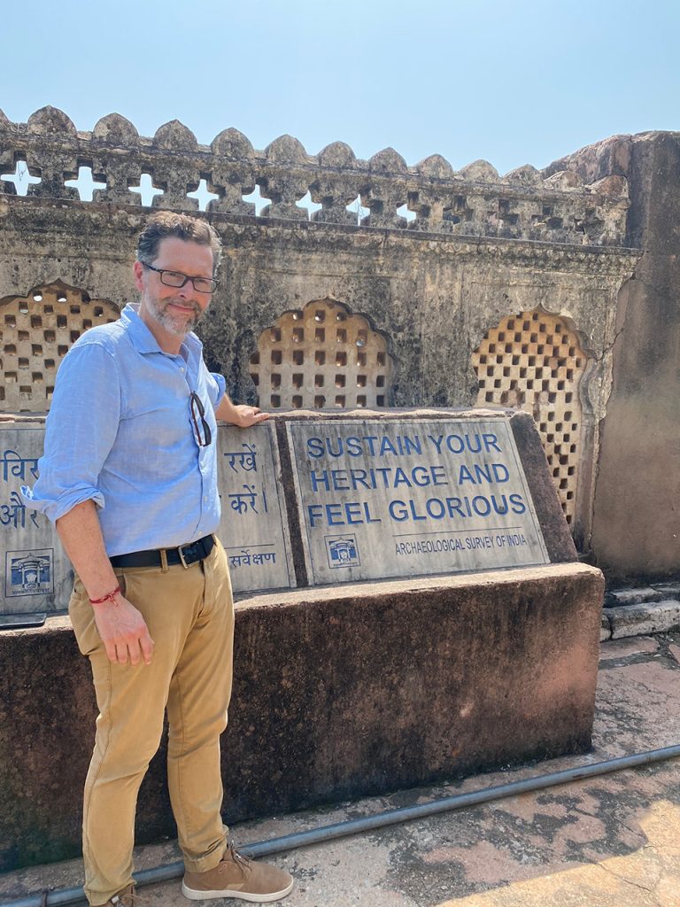Rob Woodside poses with his favorite motto in front of Bundi Fort in Rajasthan, India.
