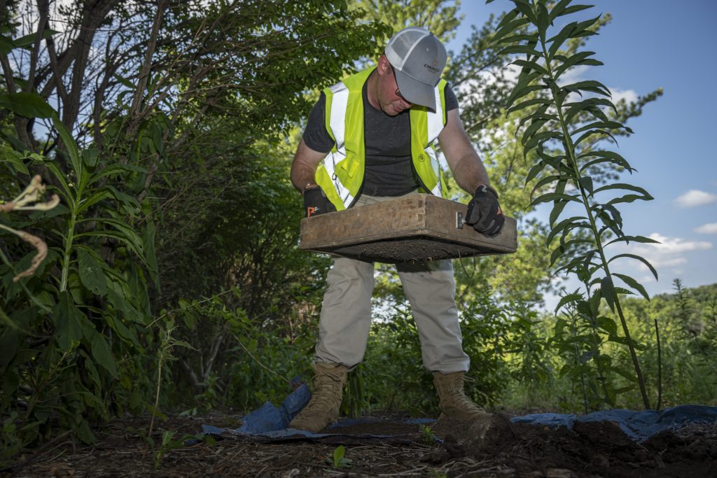 John Griffin and John Gross perform shovel test pits in Creve Coeur, Missouri on July 22, 2026.